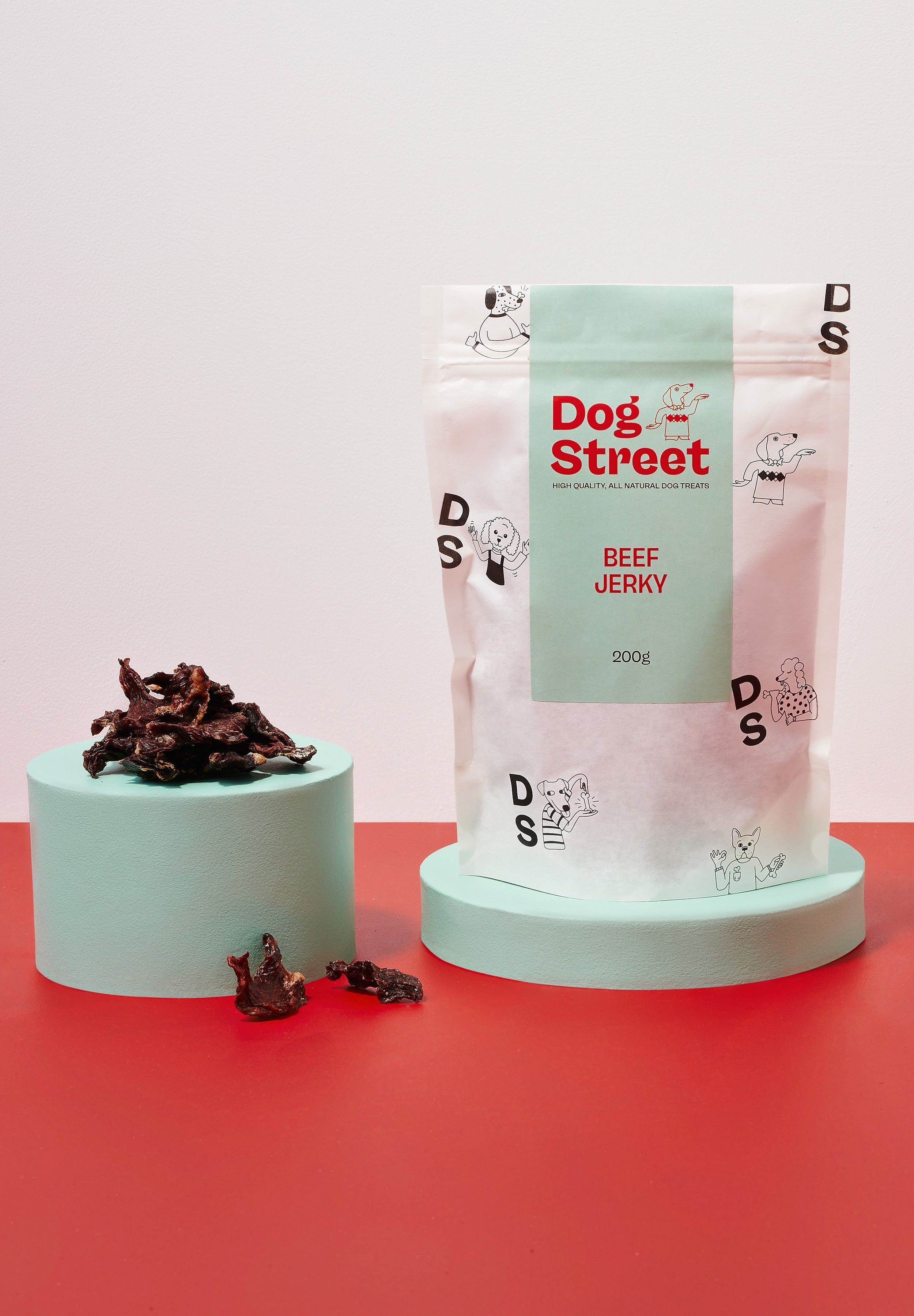 Styled shot of Dog Street Beef Jerky pack and treats.