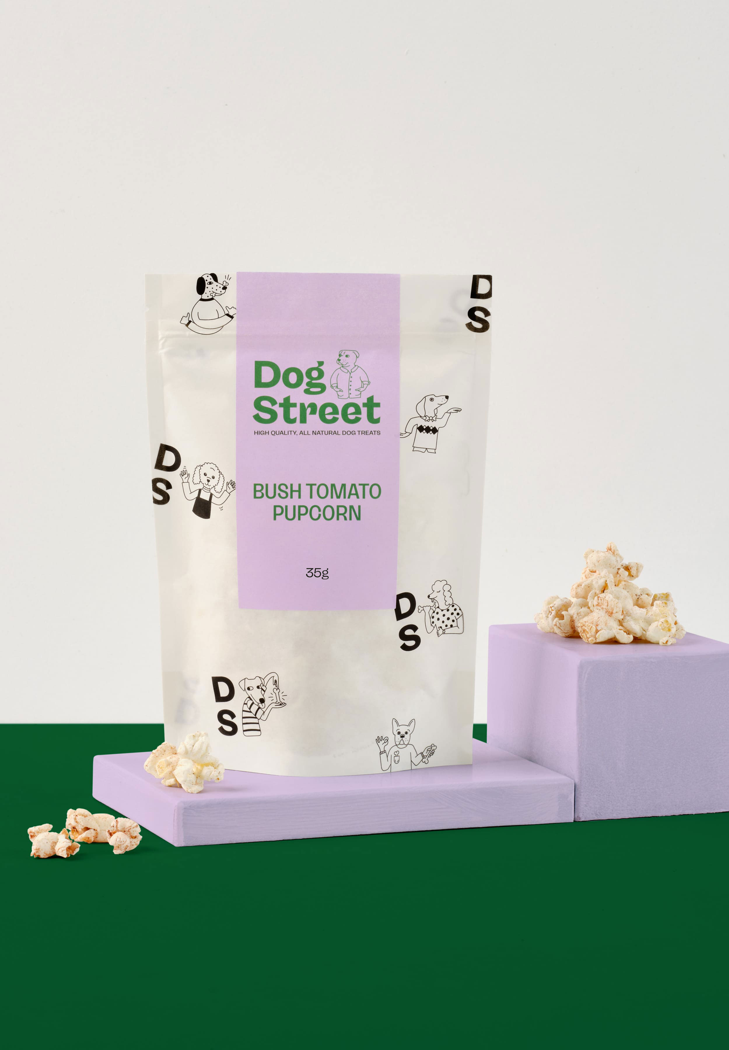 Styled shot of Dog Street Bush Tomato Popcorn pack and treats.