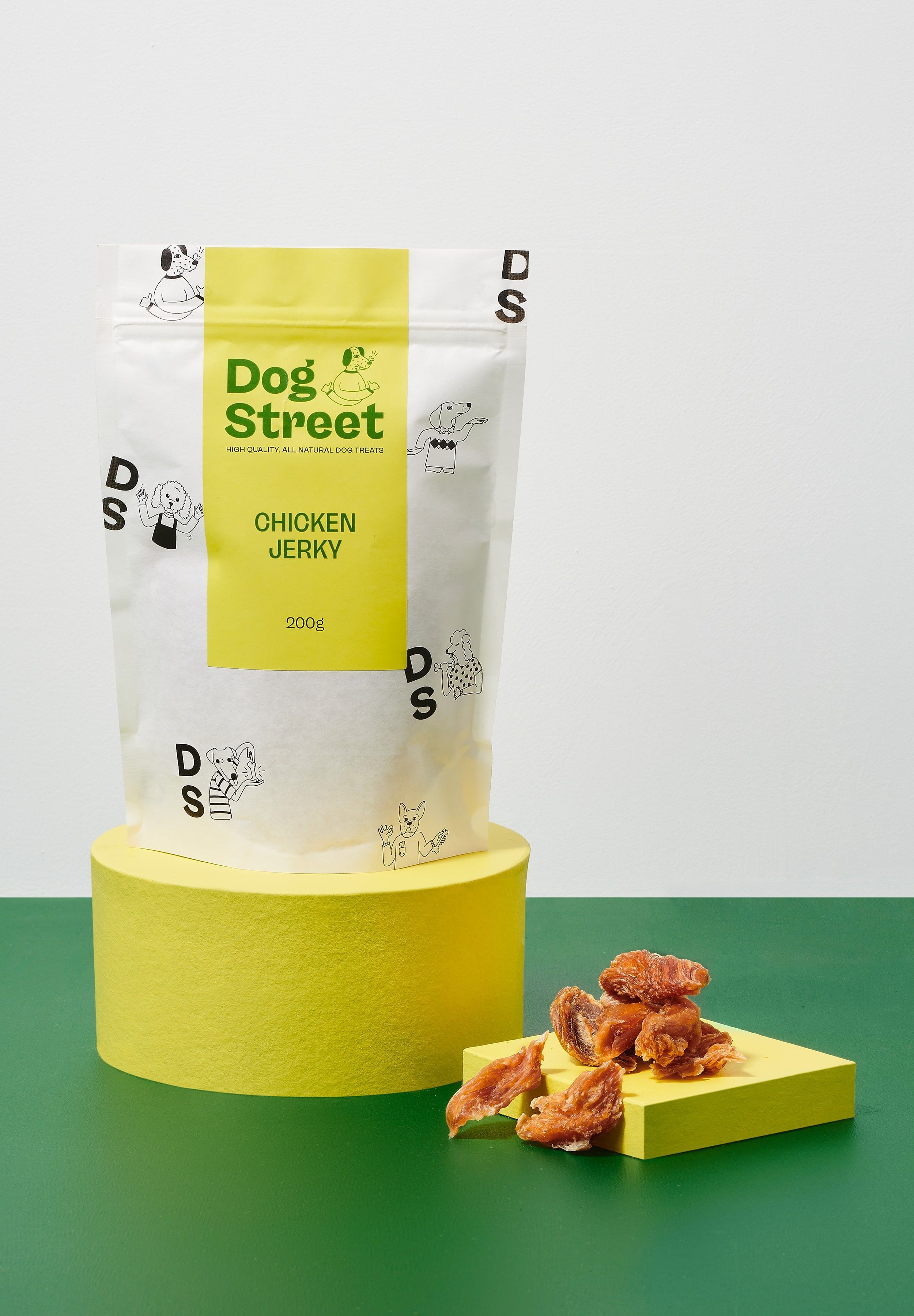 Styled shot of Dog Street Chicken Jerky pack and treats.