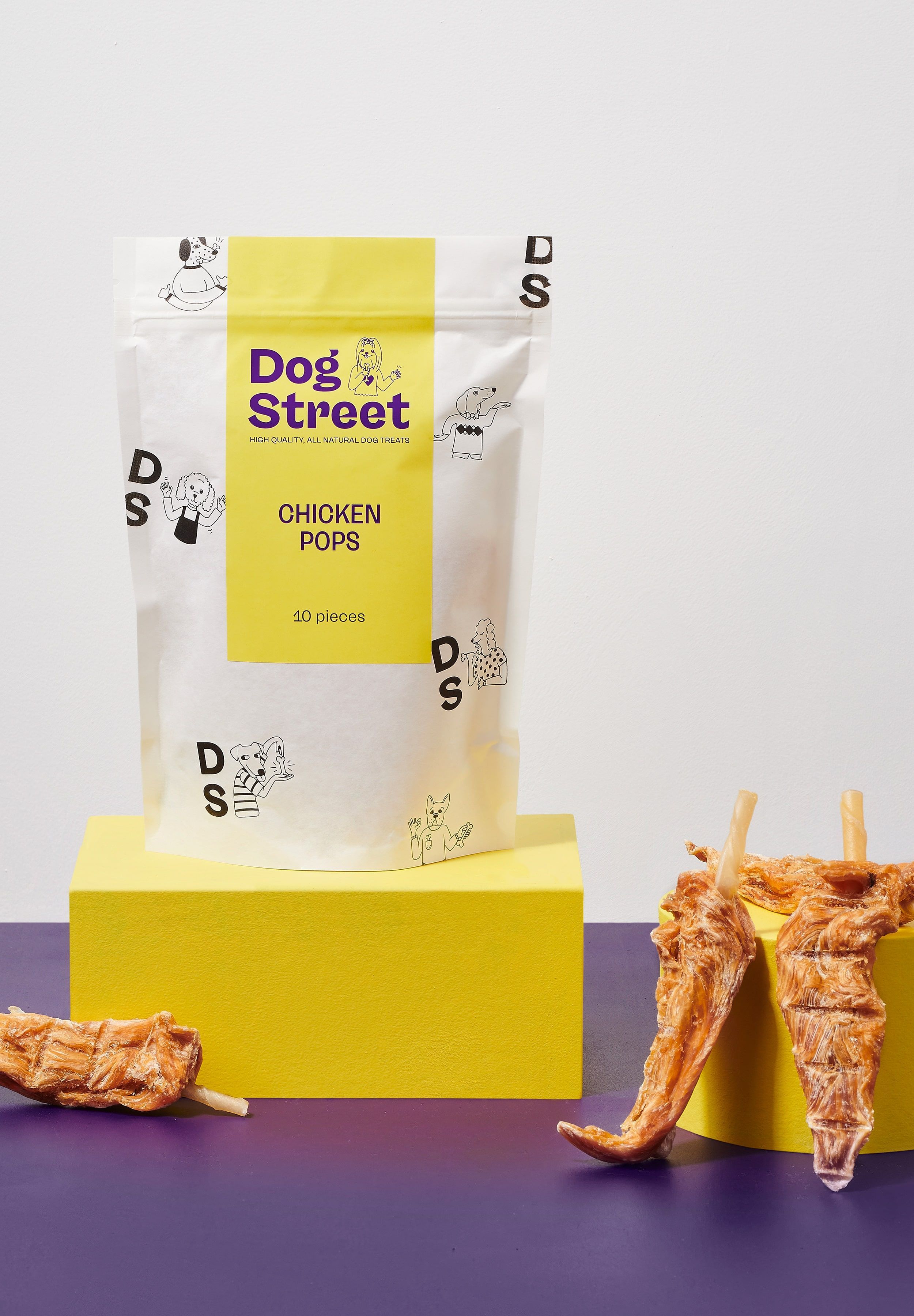 Styled shot of Dog Street Chicken Pops pack and treats.