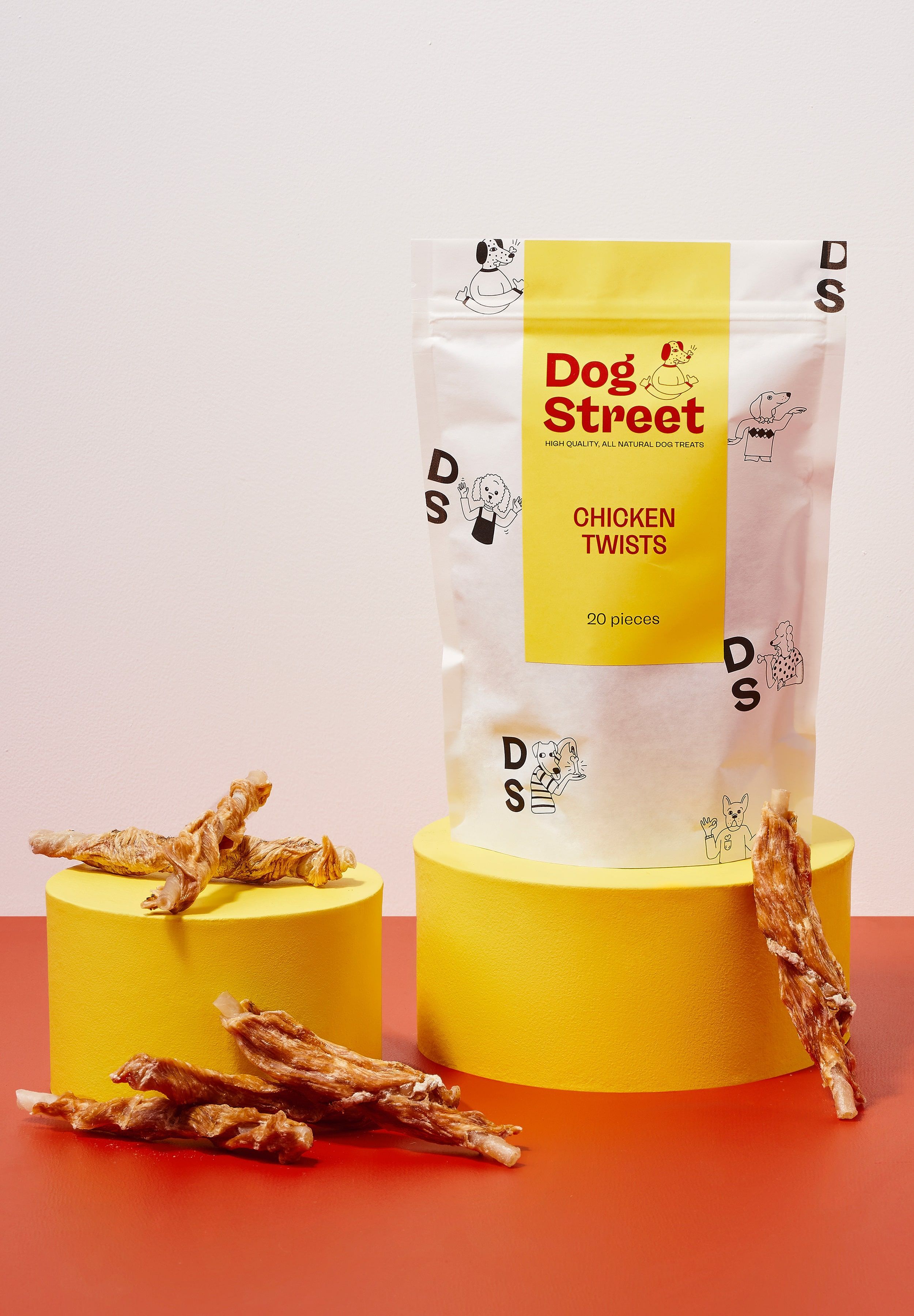 Styled shot of Dog Street Chicken Twists pack and treats.