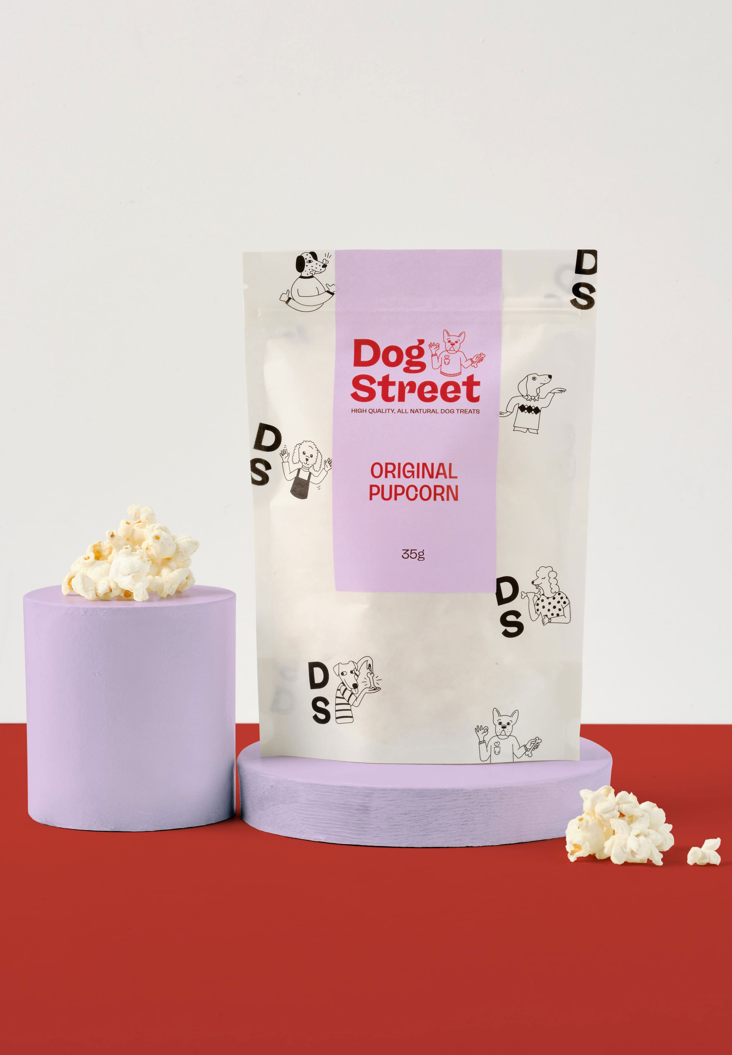 Styled shot of Dog Street Original Popcorn pack and treats.